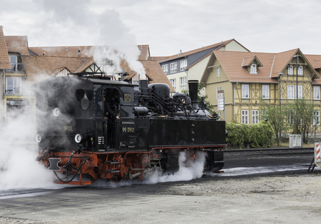 WERNIGERODE,GERMANY, SEPTEMBER 21,2016: Unidentified man driving very old steam locomotive in...