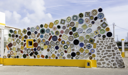 Typical Portuguese ceramics in red green yellow on white wall in sagres Portugalの写真素材