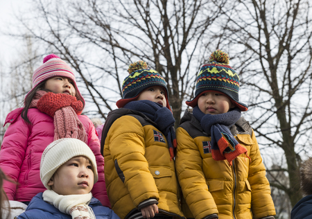 ROTTERDAM,HOLLAND - JANUARY 28 2016: four chinese children watching the opening chinese new year ceremony in Rotterdam on 28 Jan 2017,this is annual eventのeditorial素材