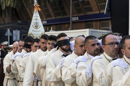 MALAGA, SPAIN - APRIL 09 2017: Unidentified people, some blindfoldded, walking in the catholic processions called Semena Santa in Malaga on April 09, 2017, this processions are every year the sunday before Easterのeditorial素材
