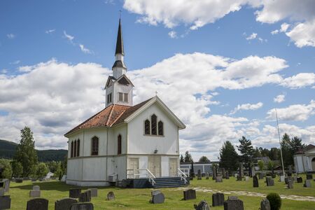 white wooden stave church near Leira in Norway with cemeteryのeditorial素材
