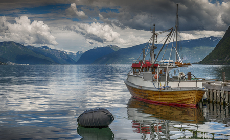 fishing boat in the harbor of Vik at the sognefjord in Norwayの写真素材