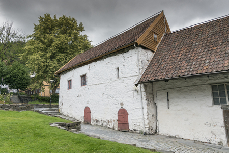 very old concrete white house build in 1666  in the village of bergen in Norwayの写真素材
