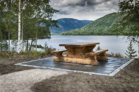 wooden bench at fjord in norwayの写真素材
