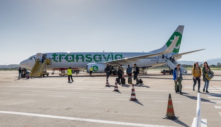 people leaving a plane on the airport of sardinia