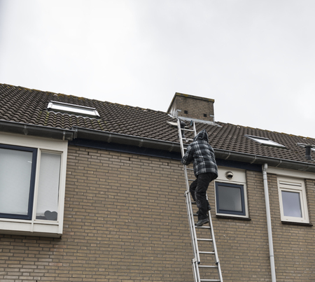 man climbing on a ladderの写真素材
