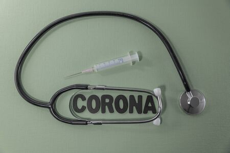 Covid 19 virus conceptual image with text in black and green and stethoscopeの写真素材