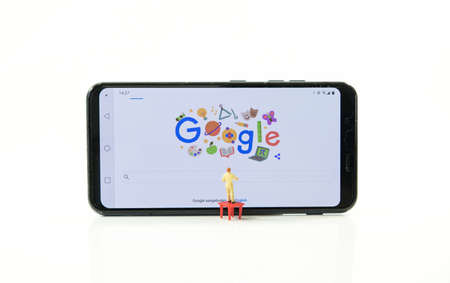 studio,holland,04-oct-2020:man on ladder looking for something on the google search bar onm internet