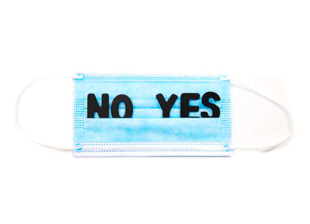 face mask and stethoscope and vaccin isolated over white background corona virus protection concept yes or noの写真素材