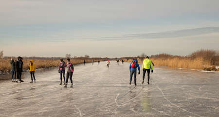 Schipluiden,Holland,14-feb-2021:people skating on the canal on the frozen lake, it has been years ago that is was so cold in Holland, people can skateのeditorial素材