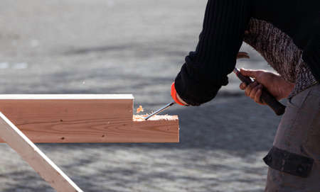 man busy with a chisel on wood