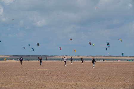 people with kites on the beachのeditorial素材