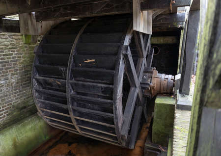 wooden wheel from an old flour millの写真素材