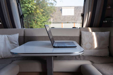 laptop computer ready to internet from inside a caravanの写真素材