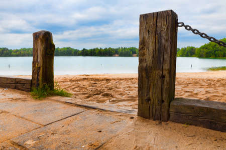 wooden poles at a lake in hollandの写真素材