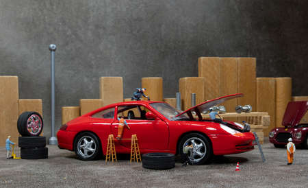little world car garage man busy with reparing carsの写真素材