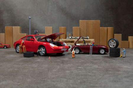 little world car garage man busy with reparing carsの写真素材