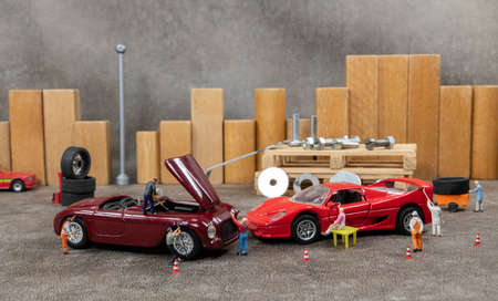 little world car garage man busy with reparing carsの写真素材