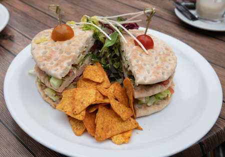 white plate wich healthy sandwich wit lettuce tomato and others on a breadの写真素材