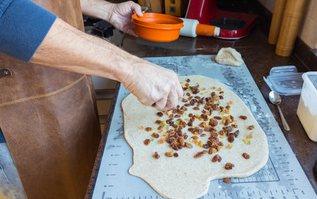 the home baker at work in the kitchen making raisin bread