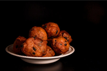 Dutch oliebollen in a white bowl with rasinsの写真素材
