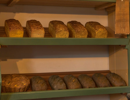 Shelf filled with loafs of bread in a bakeryの写真素材