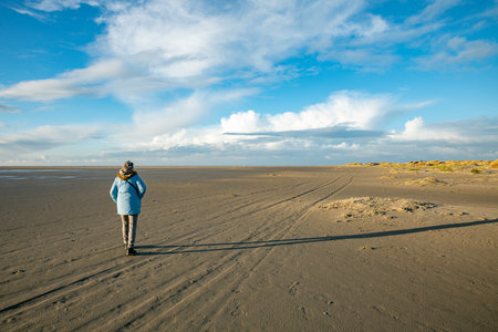woman wlaking on the south part of the island texelの写真素材