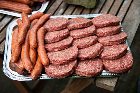 several women pieces of meat ready for barbecueの写真素材