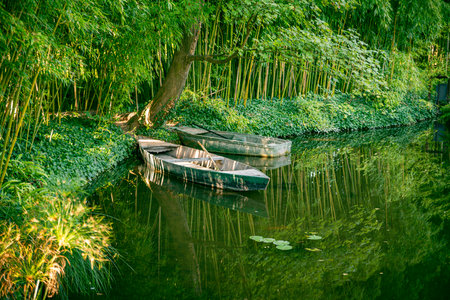 two boats and plants in the gardens of monet in franceの写真素材