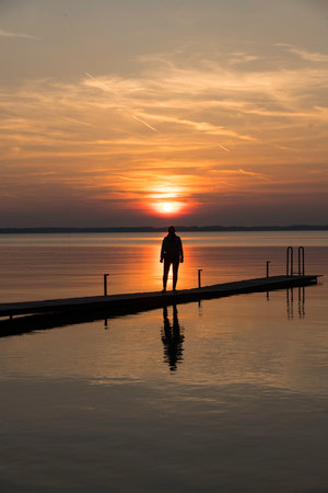 a beautiful red and orange sunset at a lake in Germanyの写真素材