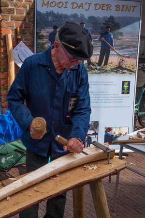 hollowing out a piece of wood to make a midwinter hornのeditorial素材