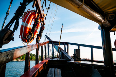 old brown wooden ship and a tropical islandの写真素材