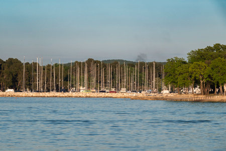 blue sea with a harbor with boats during tourist season in summer in croatiaの写真素材