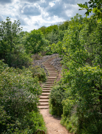 the hiking trail with steep steps up to the top of the Roche de Solutre to the giant rock to climb...