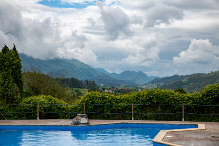 private swimming pool with view of the mountains of the picos de europa as backgroundの写真素材