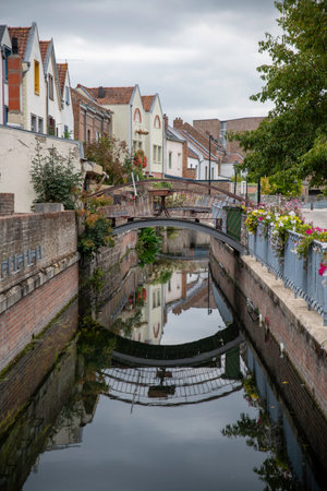 bridge over the somme in amiens infrance with bridge ,flowers and reflection in the water in saint leuの写真素材