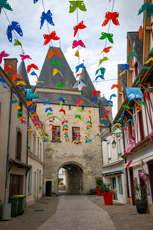 la ferte bernard,france,22-sept-2025: the shopping street in la ferte bernard with colorfull decorations of butterflies and at the end the Saint Julien gateの写真素材