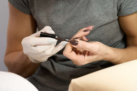 Woman doing manicure for herself. High quality photoの写真素材