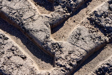 Close-up shot of tractor track at the the plowing fieldの写真素材