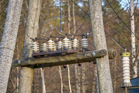 An old wooden electric pole power lines and wires with blue sky background