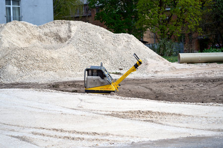 RIGA, LATVIA - MAY 13, 2022: Vibration plate machine standing alone on construction siteのeditorial素材