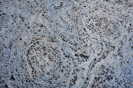 Weathered sandstone texture background with holes and veins.