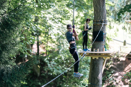 Enjoy thrilling zipline adventures in lush greenery and towering trees at this exciting adventure parkの写真素材