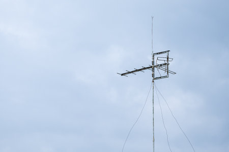 An old television antenna against blue sky.の写真素材