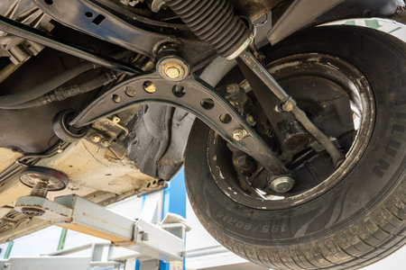 Riga, Latvia - June 8, 2025: A comprehensive examination of the BMW e30 car suspension elements and...
