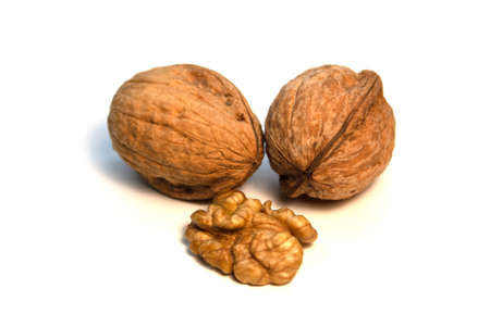 Walnuts in a shell and without it on a white backgroundの写真素材