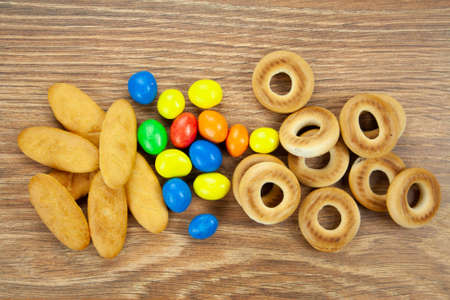 Bakery and candies for tea coffee milk juice on a wooden tableの写真素材