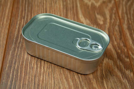 Tin can closeup isolated on wooden backgroundの写真素材