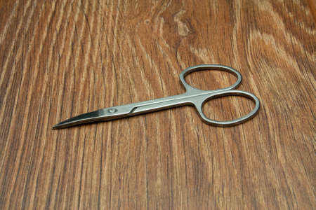 Close-up manicure scissors isolated on wooden backgroundの写真素材