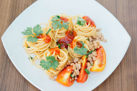 spaghetti with tomato sauce on wood backgroundの写真素材